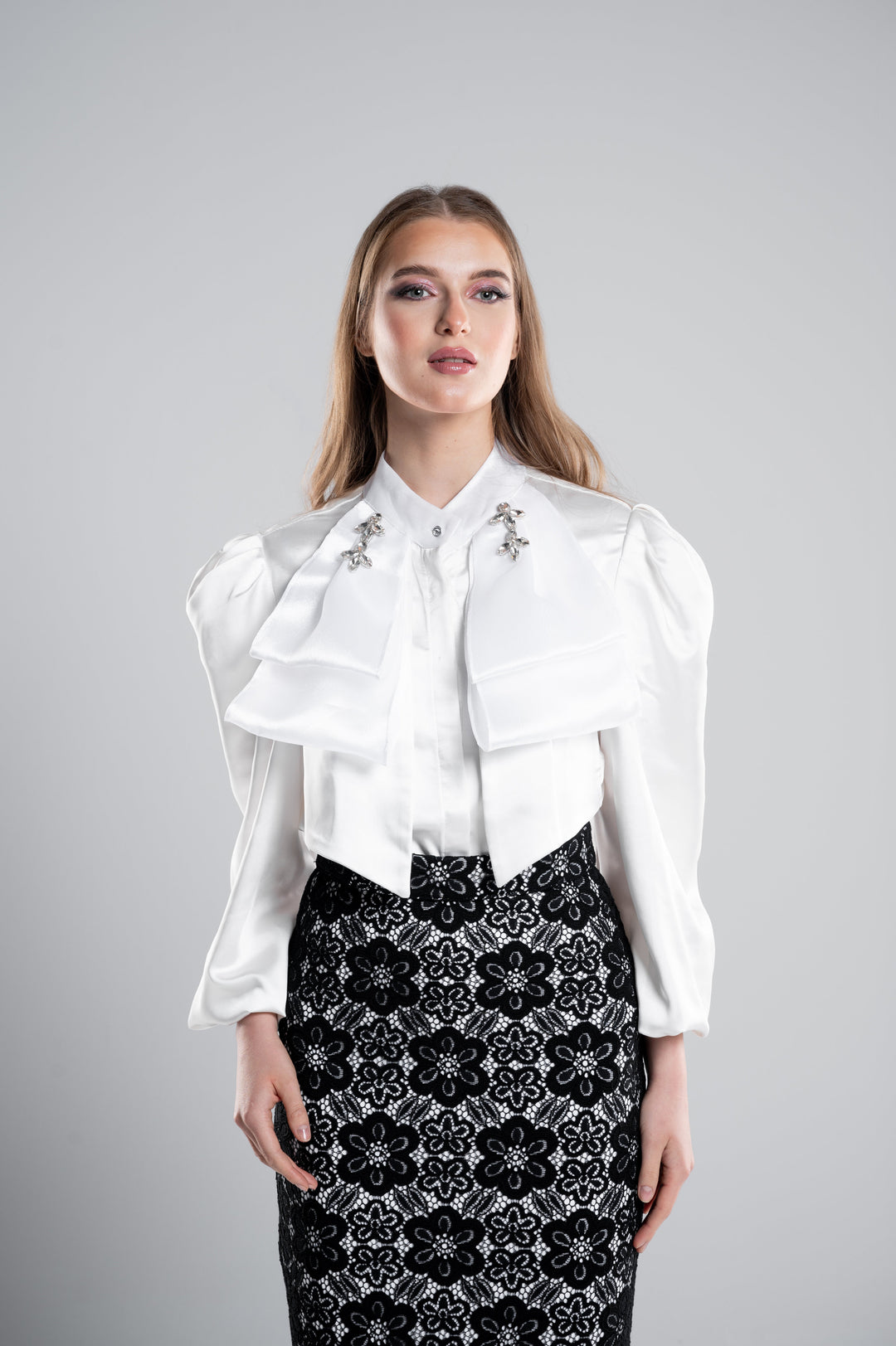 A SATIN BLOUSE WITH 3 LAYERS OF BOW ON EACH SIDE AND COLLAR CRYSTALS